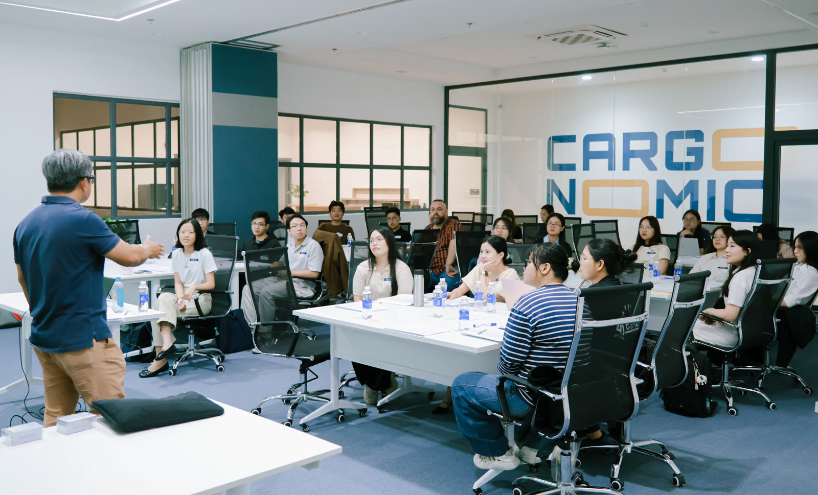 Cargonomics students in a classroom training session at the HCMC office, instructor presenting at the front